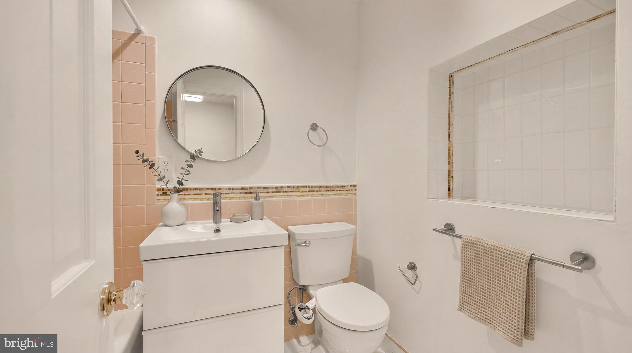 3640 Brandywine Street Northwest Washington, DC 20008 - Photo 26 of 39 a bathroom with a toilet sink vanity and mirror