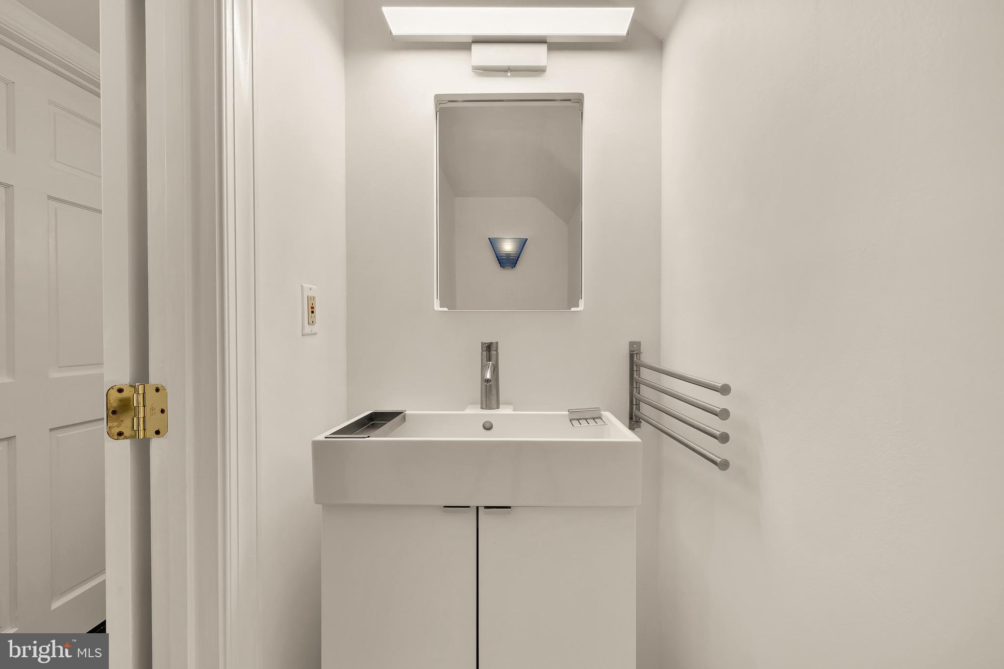 3640 Brandywine Street Northwest Washington, DC 20008 - Photo 33 of 39 a bathroom with a sink a mirror and a toilet