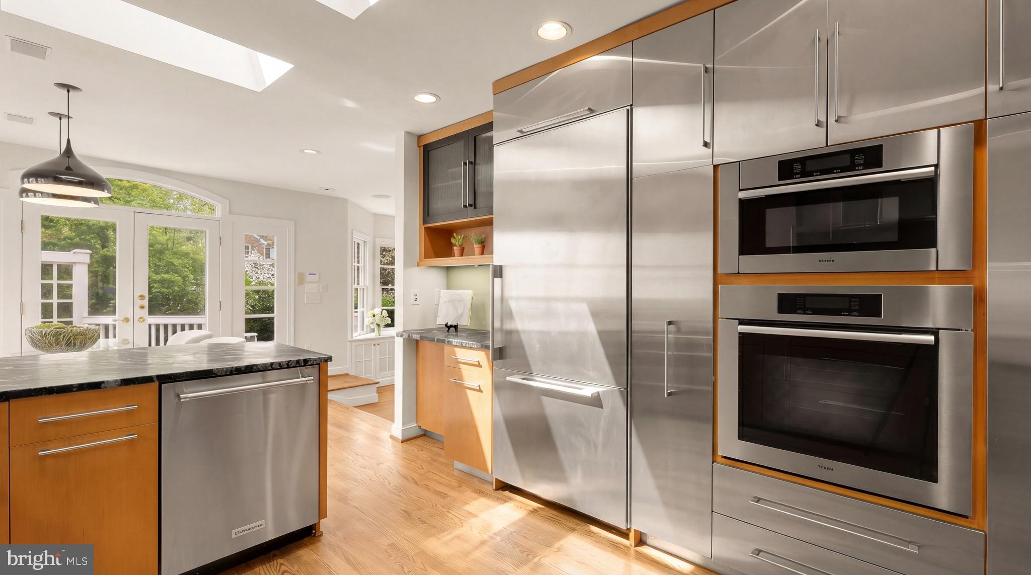 3640 Brandywine Street Northwest Washington, DC 20008 - Photo 6 of 39 a kitchen with stainless steel appliances kitchen island granite countertop a refrigerator a stove a sink and a microwave