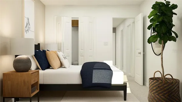 a bedroom with a bed lamp and a potted plant