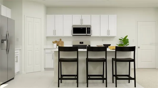 a kitchen with a table chairs refrigerator and cabinets