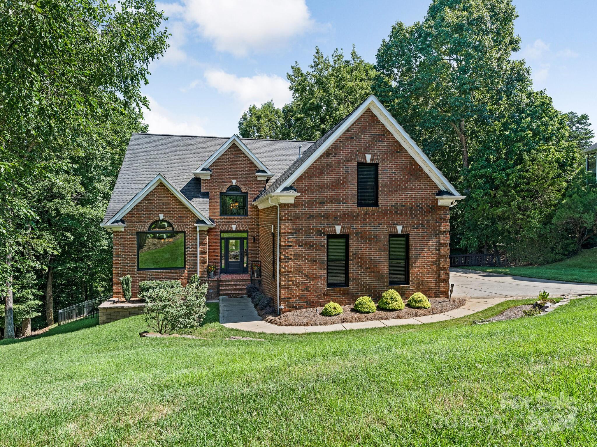 a front view of house with yard and green space