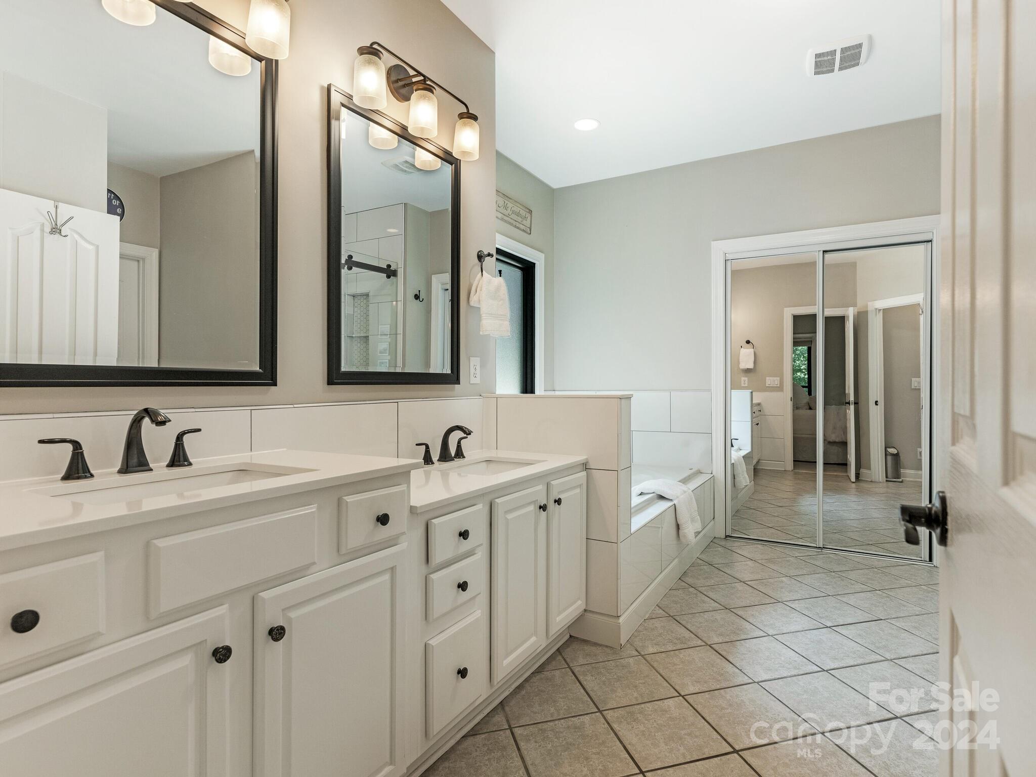 3234 Planters Ridge Road Charlotte, NC 28270 - Photo 15 of 33 a spacious bathroom with a double vanity sink mirror and