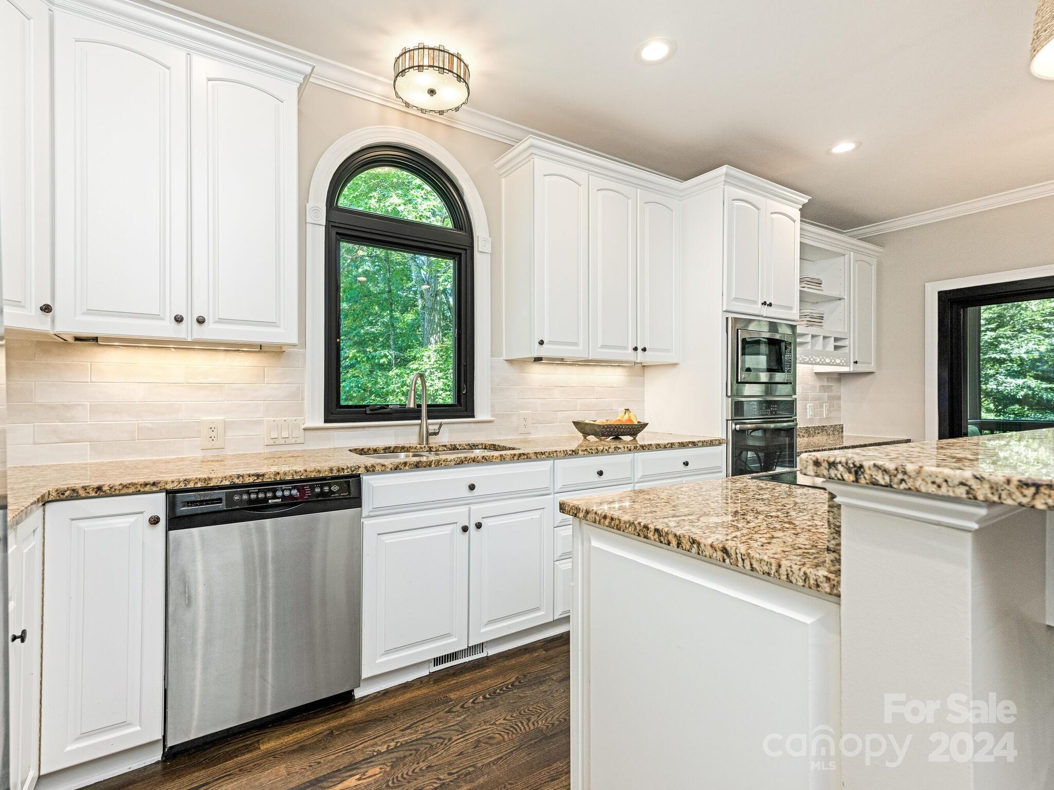 3234 Planters Ridge Road Charlotte, NC 28270 - Photo 7 of 33 a kitchen with a stove a sink a window and cabinets