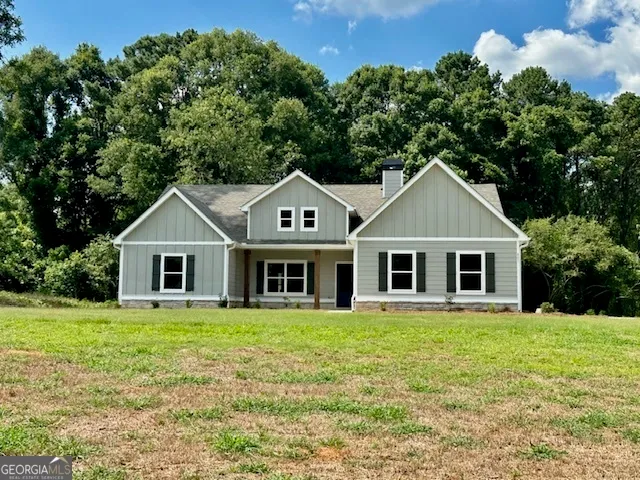 a front view of house with yard and green space