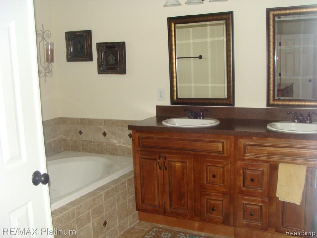 4720 Hogback Road Fowlerville, MI 48836 - Photo 9 of 18 Bathroom with 2 sinks
