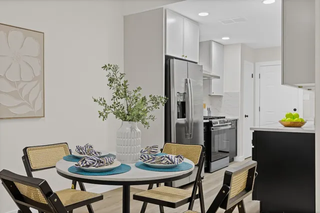 a dining room with furniture and wooden floor