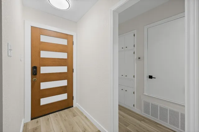 a bathroom with a granite countertop sink and a toilet