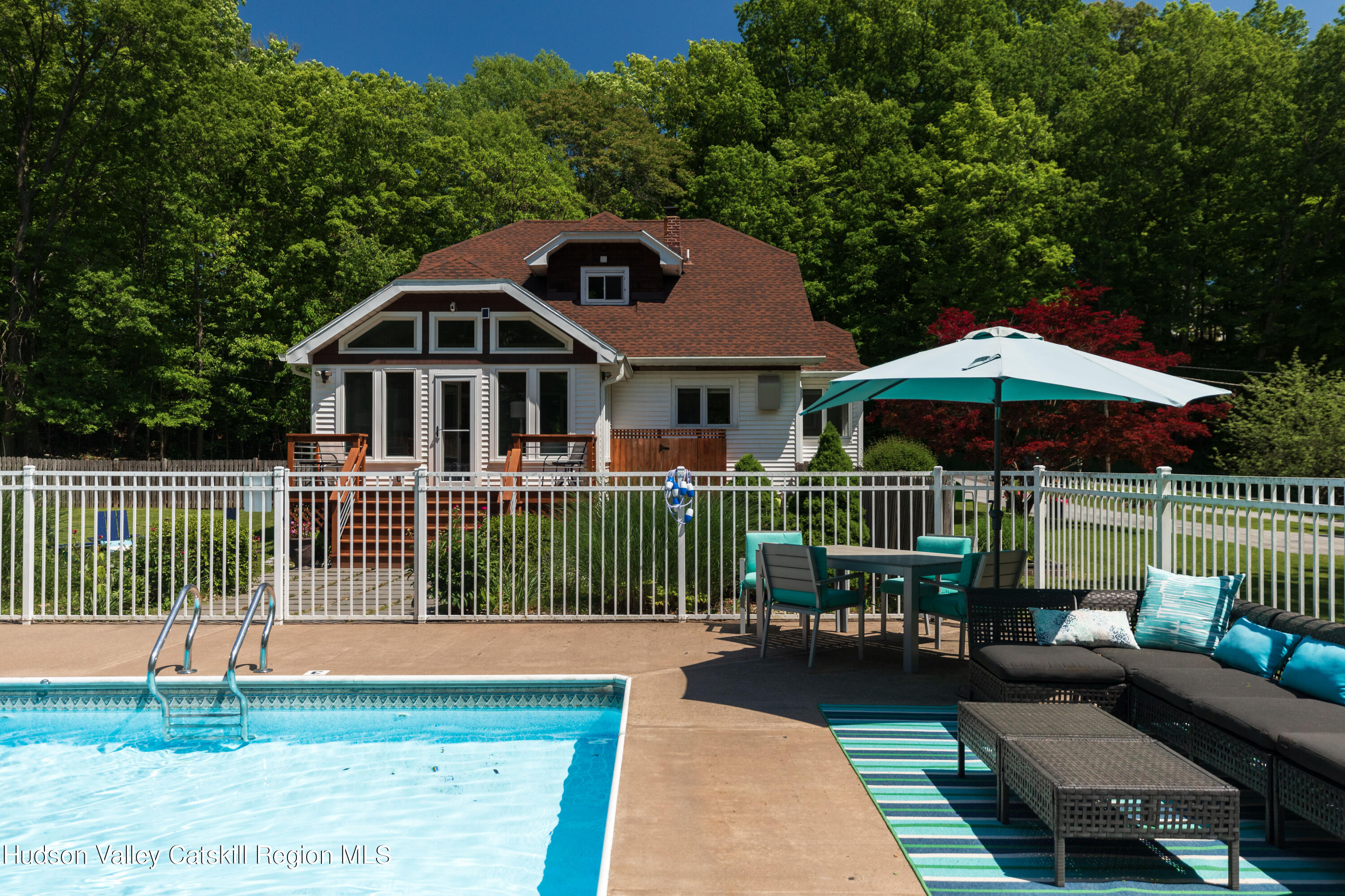 12 Church Hill Road Rifton, NY 12471 - Photo 2 of 33 a roof deck with a table and chairs under an umbrella