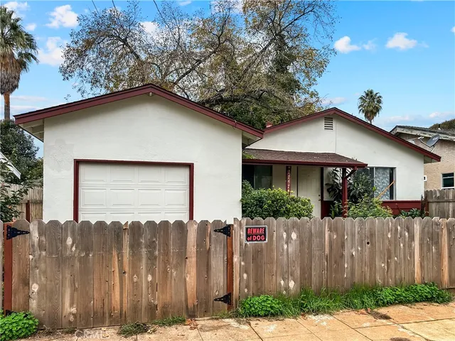 a front view of house with wooden fence