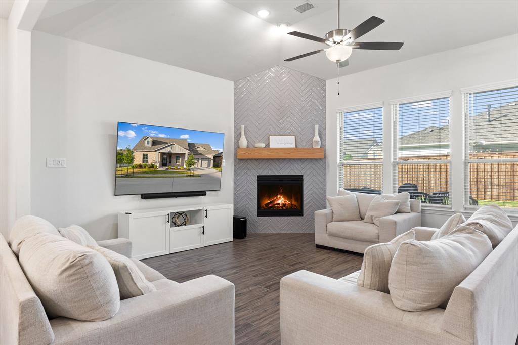 8808 Royal Star Road Rowlett, TX 75089 - Photo 5 of 40 a living room with furniture a flat screen tv and a fireplace