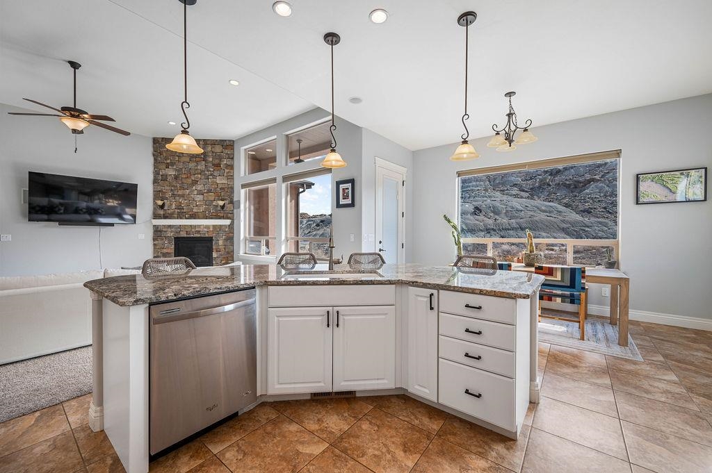 2283 Trail Ridge Road Grand Junction, CO 81507 - Photo 15 of 35 a open kitchen with stainless steel appliances granite countertop a sink a stove and a wooden floor