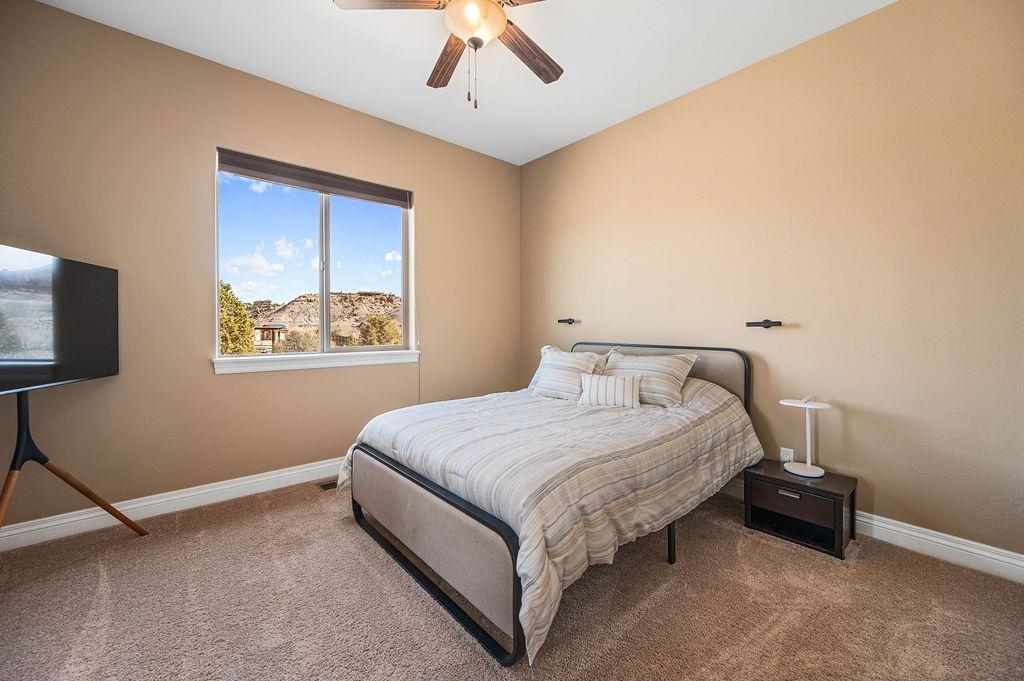 2283 Trail Ridge Road Grand Junction, CO 81507 - Photo 22 of 35 a bedroom with a bed and a flat screen tv