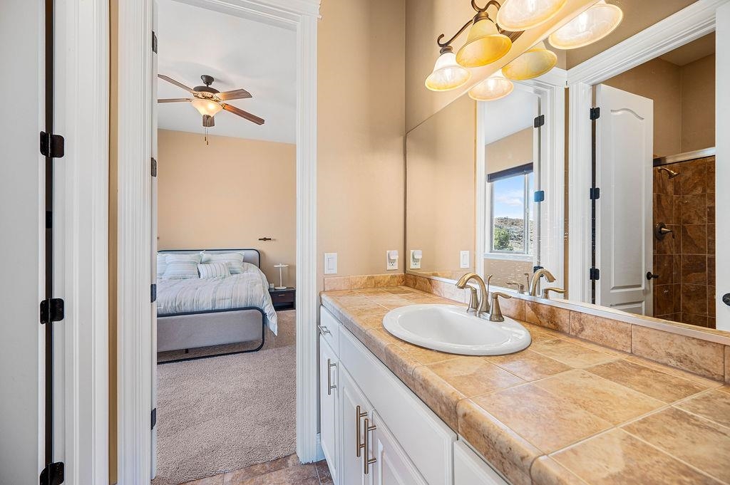 2283 Trail Ridge Road Grand Junction, CO 81507 - Photo 23 of 35 a bathroom with a granite countertop sink and a mirror