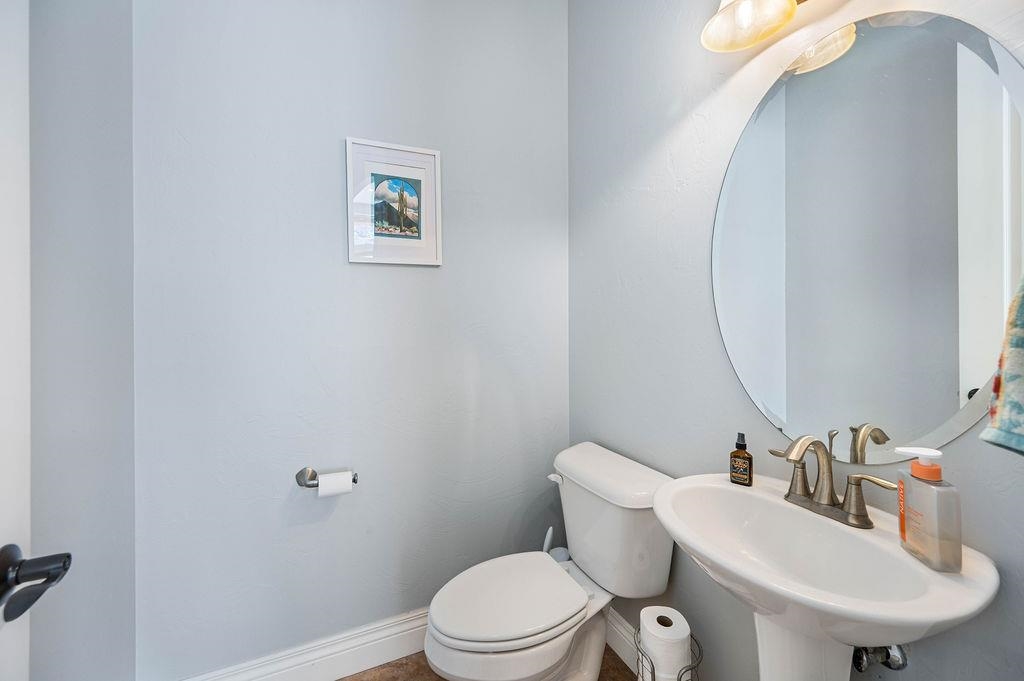 2283 Trail Ridge Road Grand Junction, CO 81507 - Photo 26 of 35 a bathroom with a sink a toilet and a mirror