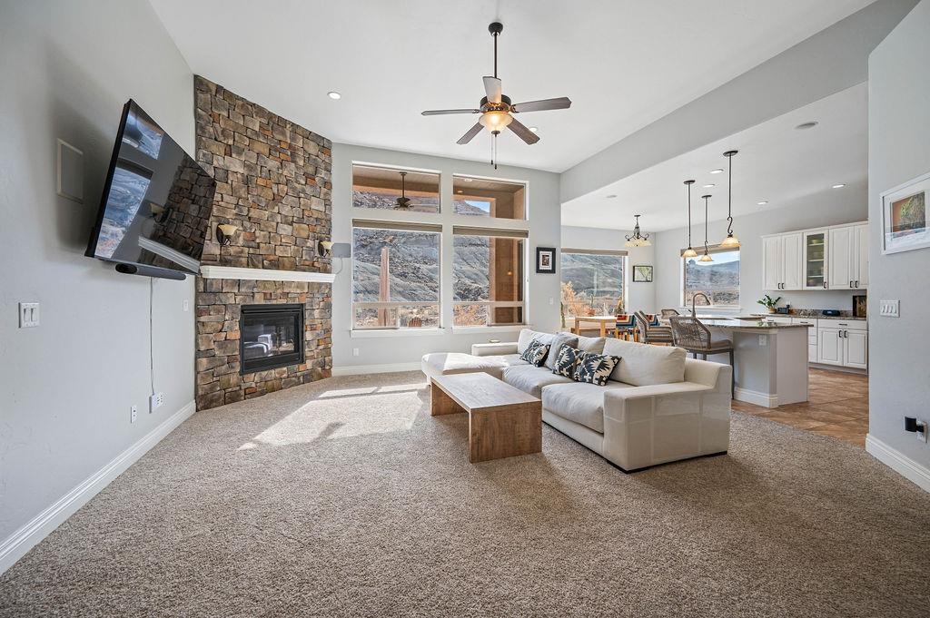 2283 Trail Ridge Road Grand Junction, CO 81507 - Photo 10 of 35 a living room with furniture a fireplace and a flat screen tv