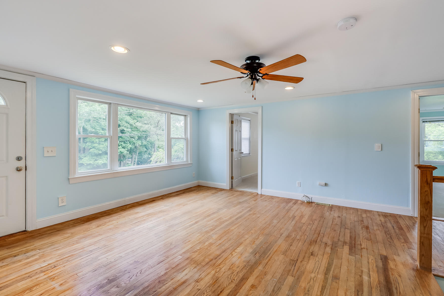 16 Florence Street Monument Beach, MA 02532 - Photo 4 of 35 an empty room with wooden floor fan and windows