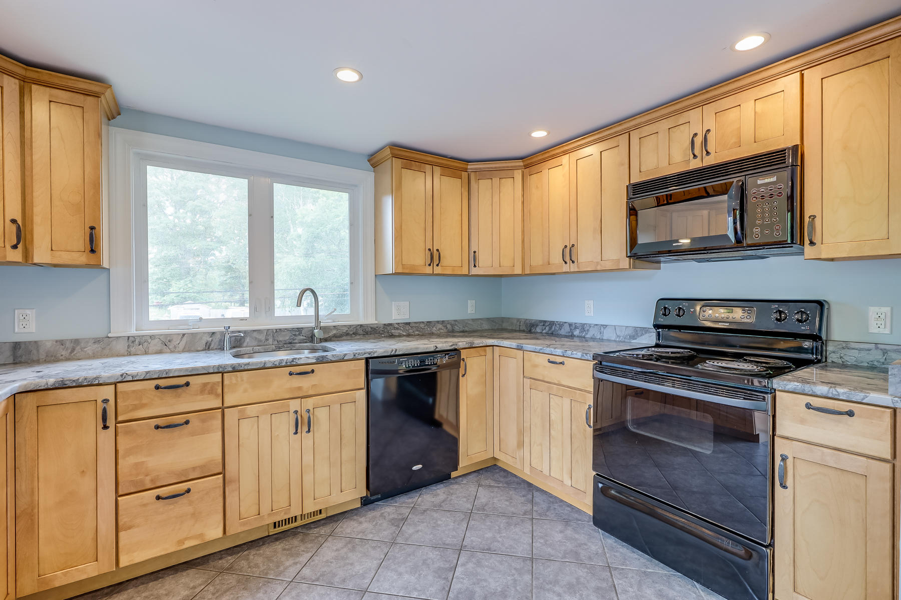 16 Florence Street Monument Beach, MA 02532 - Photo 9 of 35 a kitchen with white cabinets appliances and a window