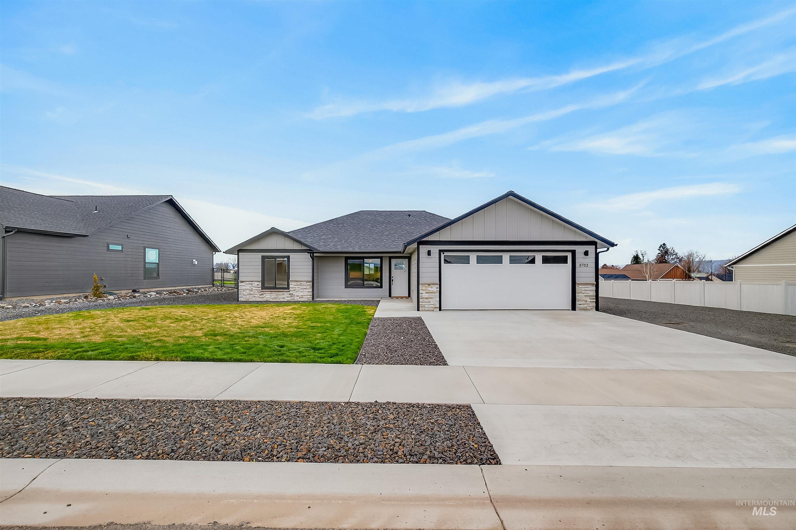 3732 Skyview Drive Lewiston, ID 83501 - Photo 1 of 47 Modern farmhouse style home with stone siding, board and batten siding, concrete driveway, and a garage