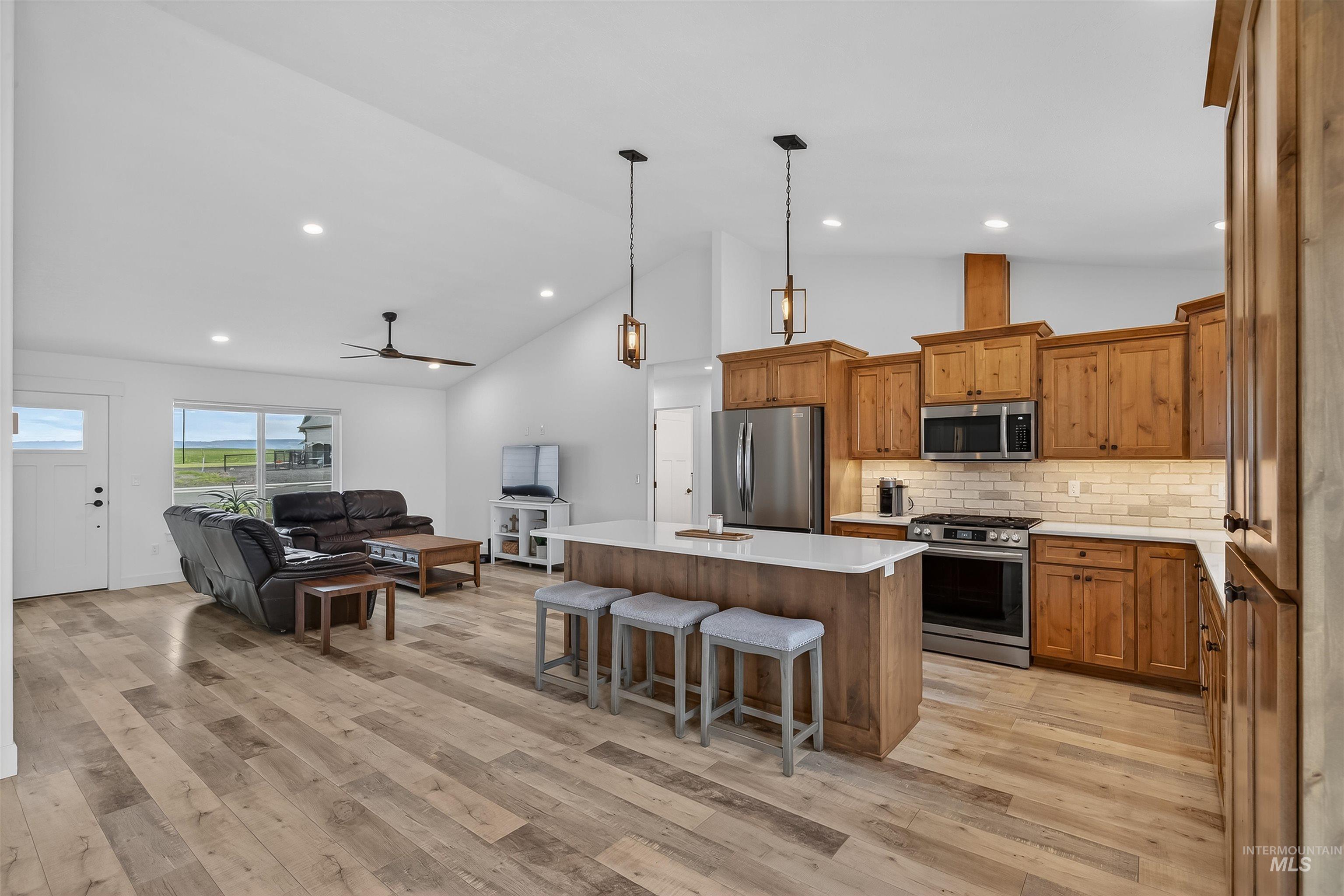 3732 Skyview Drive Lewiston, ID 83501 - Photo 47 of 47 Kitchen with wood finish cabinetry, a center island, open floor plan, stainless steel appliances, and light wood-type flooring