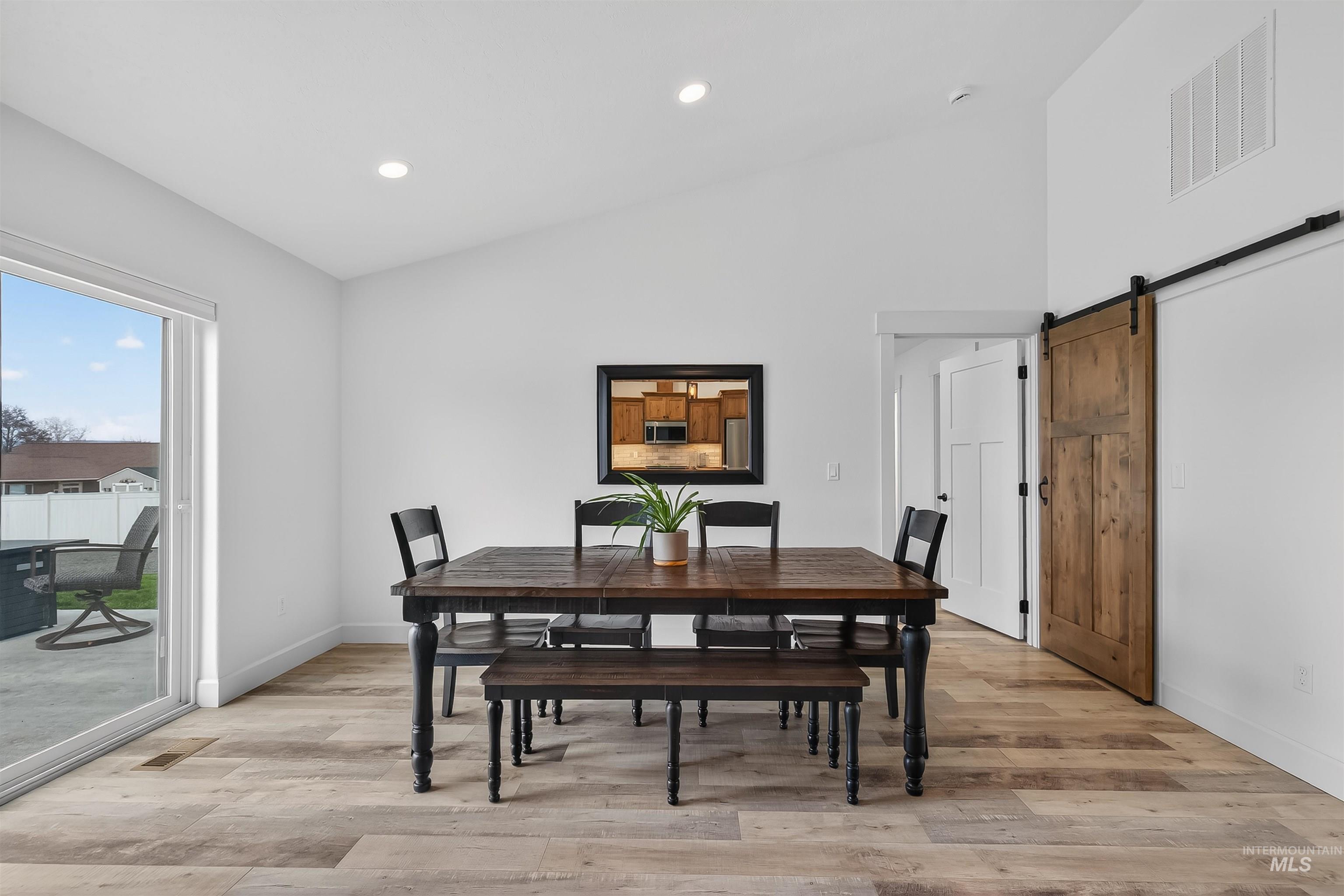 3732 Skyview Drive Lewiston, ID 83501 - Photo 15 of 47 Dining area with a barn door, light wood-style flooring, lofted ceiling, and recessed lighting