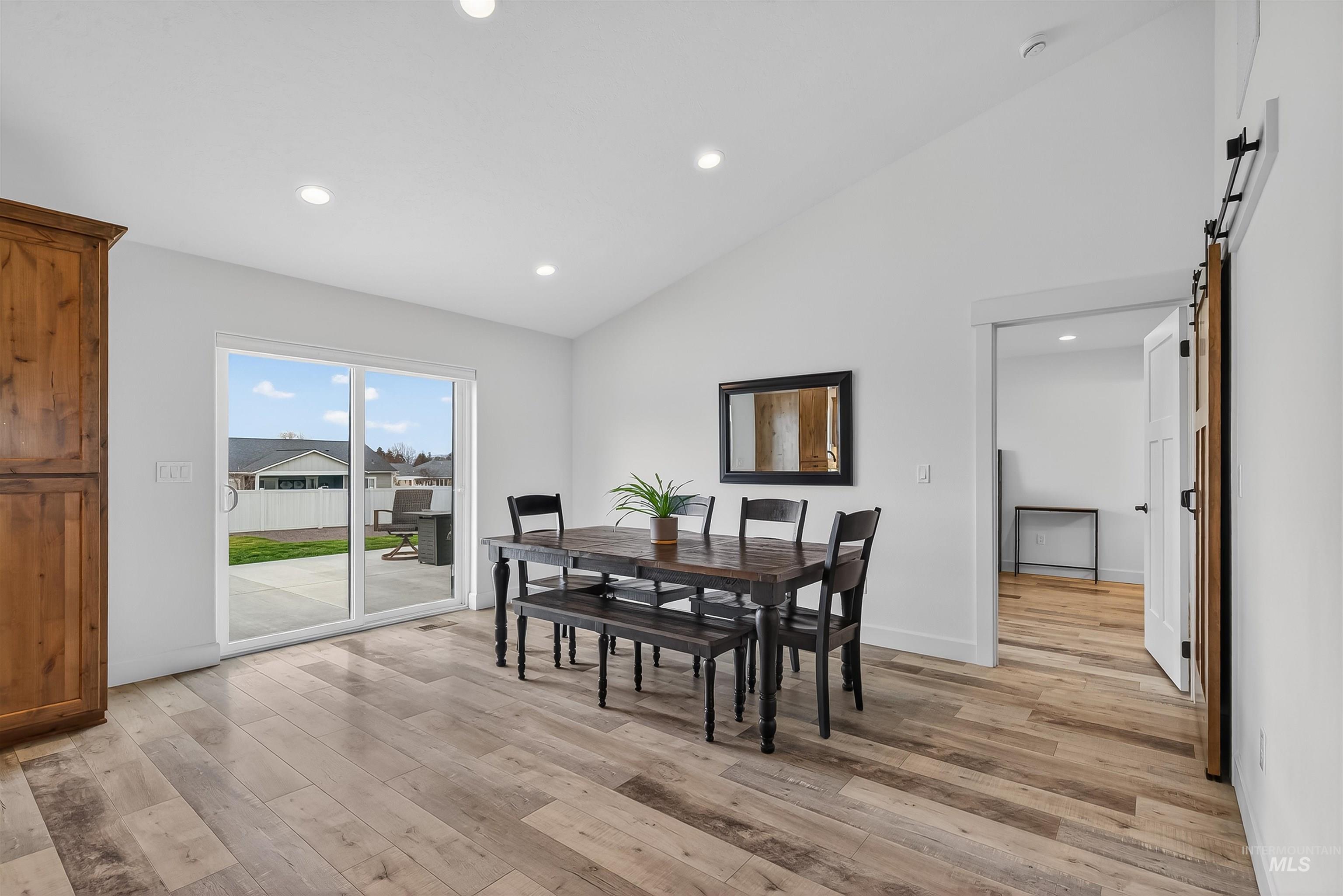 3732 Skyview Drive Lewiston, ID 83501 - Photo 17 of 47 Dining room with a barn door, lofted ceiling, light wood-style floors, and recessed lighting