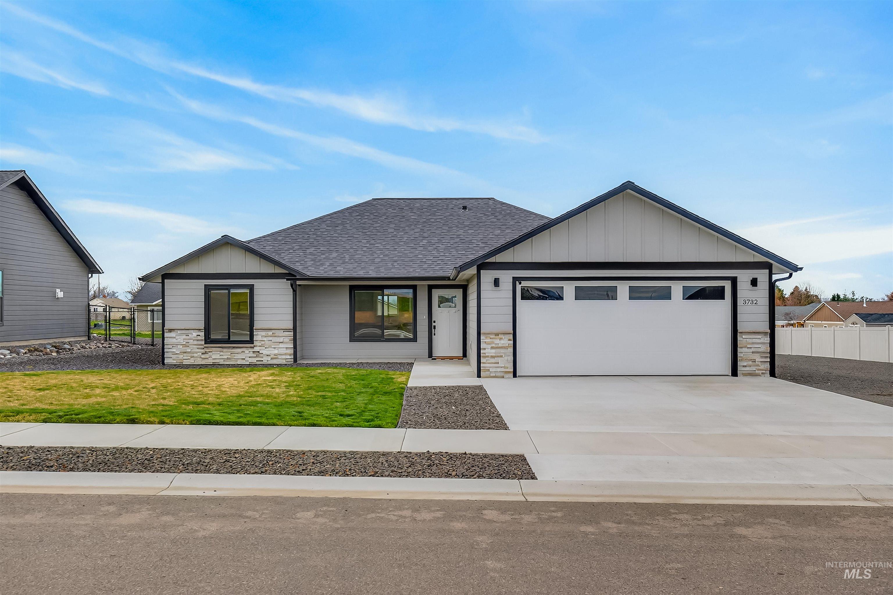 3732 Skyview Drive Lewiston, ID 83501 - Photo 2 of 47 View of front of property featuring stone siding, board and batten siding, a shingled roof, driveway, and an attached garage