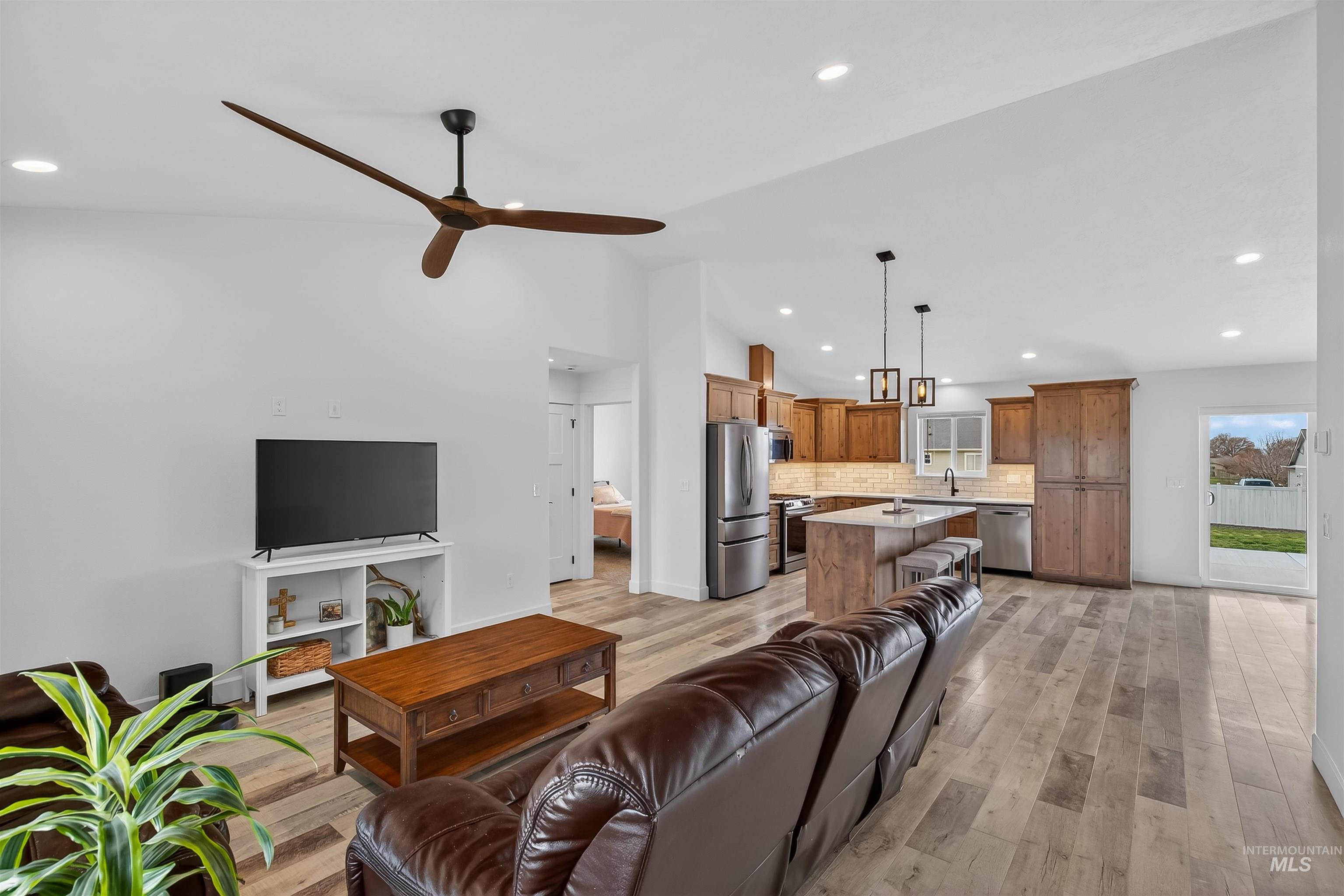 3732 Skyview Drive Lewiston, ID 83501 - Photo 20 of 47 Living room with light wood-style flooring, recessed lighting, lofted ceiling, and ceiling fan