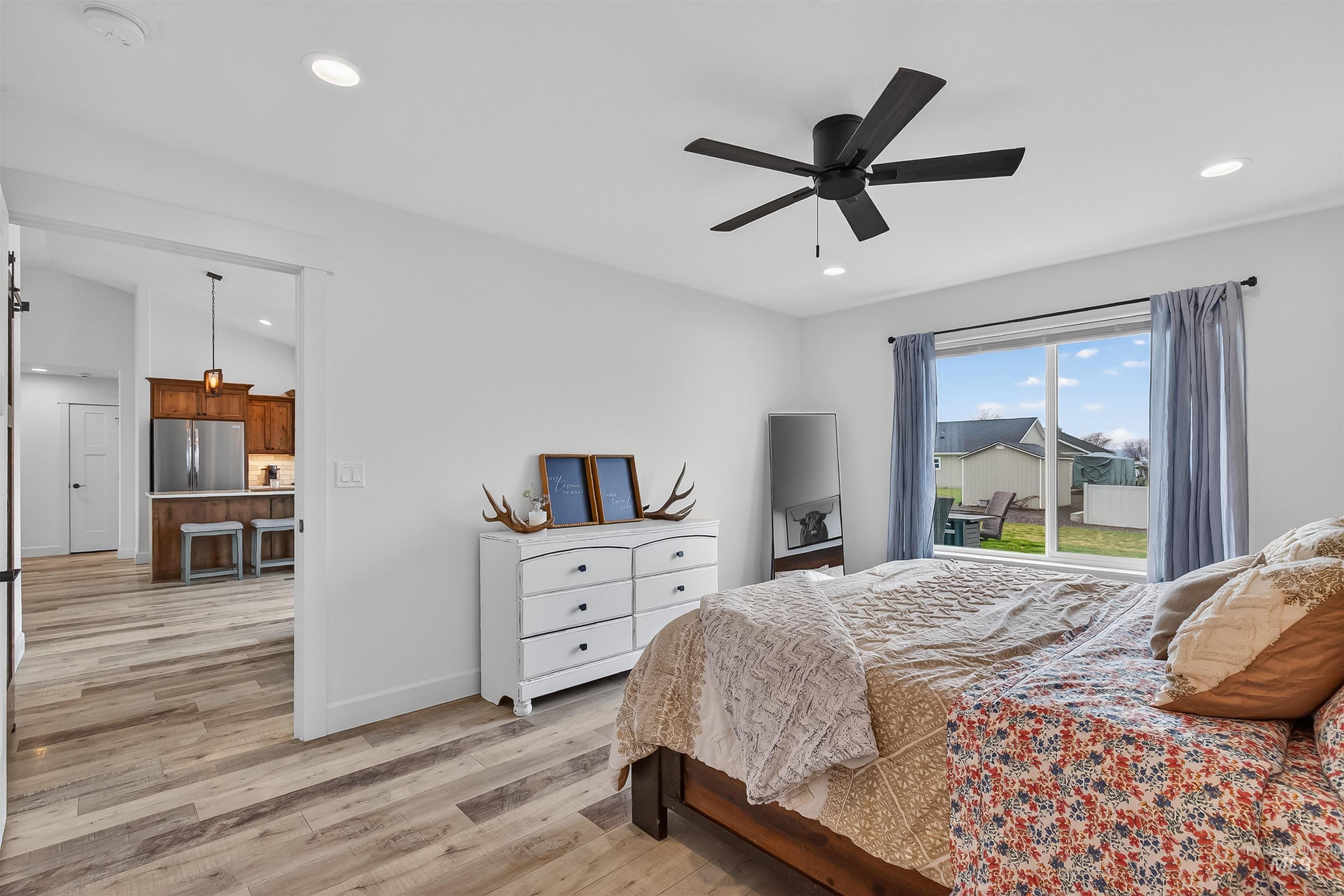 3732 Skyview Drive Lewiston, ID 83501 - Photo 25 of 47 Bedroom with light wood-style floors, freestanding refrigerator, ceiling fan, recessed lighting, and lofted ceiling