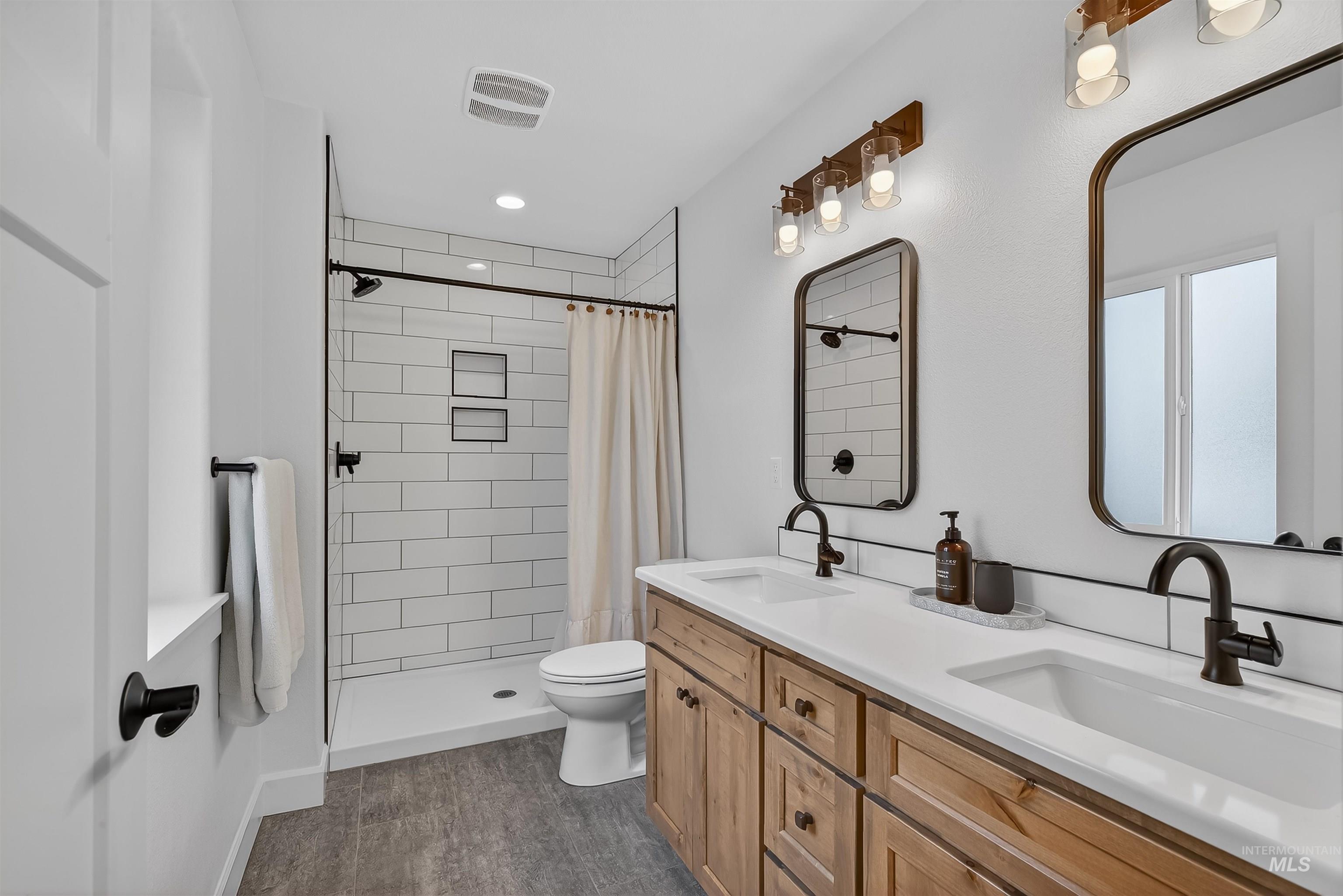 3732 Skyview Drive Lewiston, ID 83501 - Photo 27 of 47 Full bathroom featuring double vanity, a stall shower, and dark wood finished floors