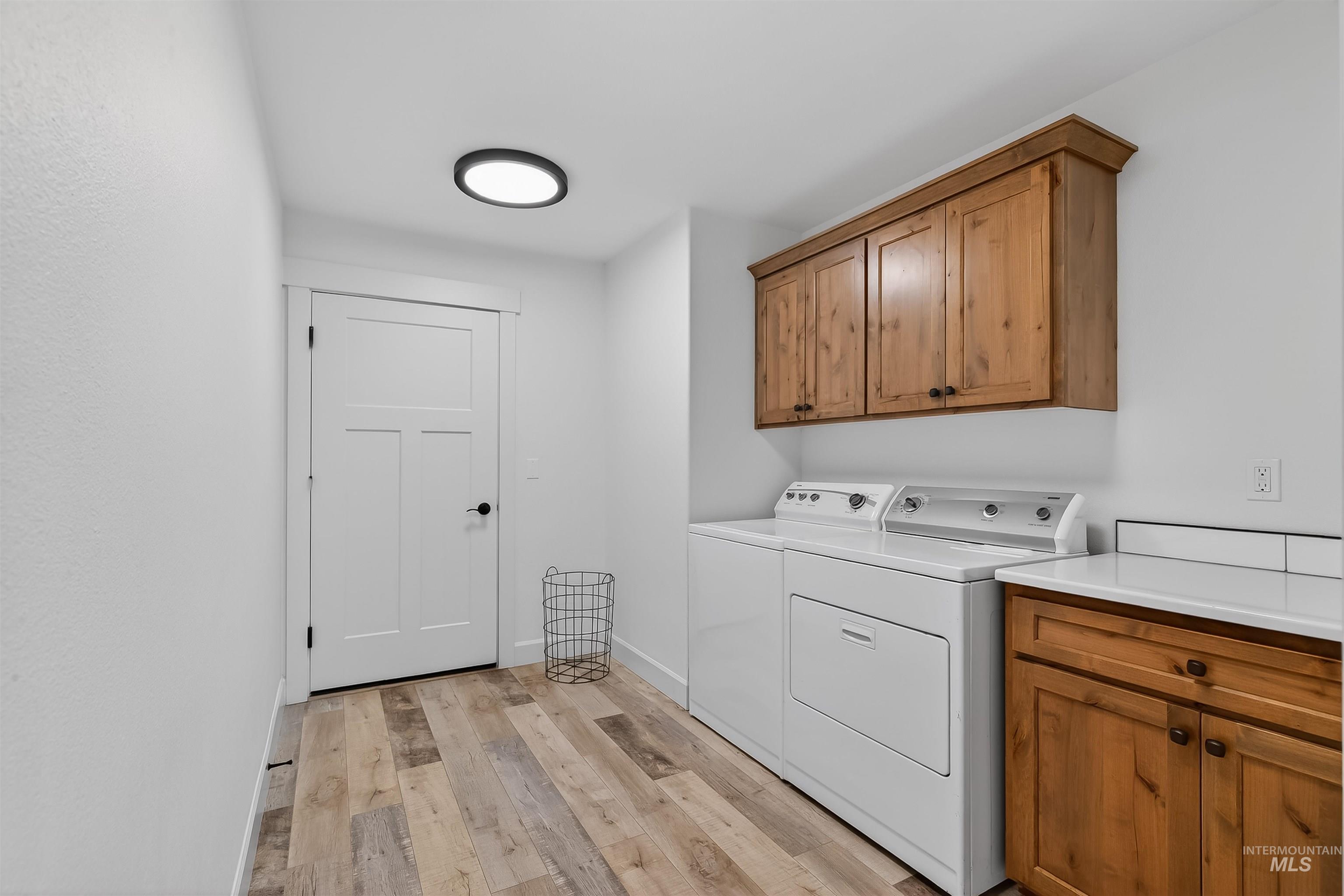 3732 Skyview Drive Lewiston, ID 83501 - Photo 34 of 47 Laundry room featuring cabinet space, light wood-type flooring, and separate washer and dryer