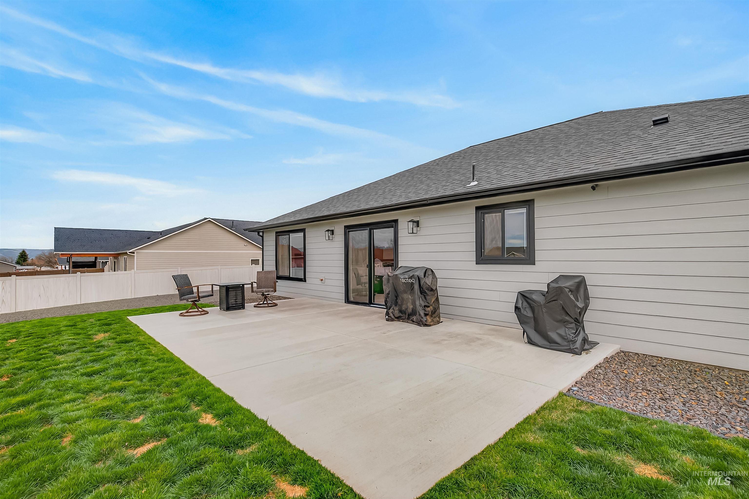 3732 Skyview Drive Lewiston, ID 83501 - Photo 37 of 47 Rear view of house featuring roof with shingles and a patio area