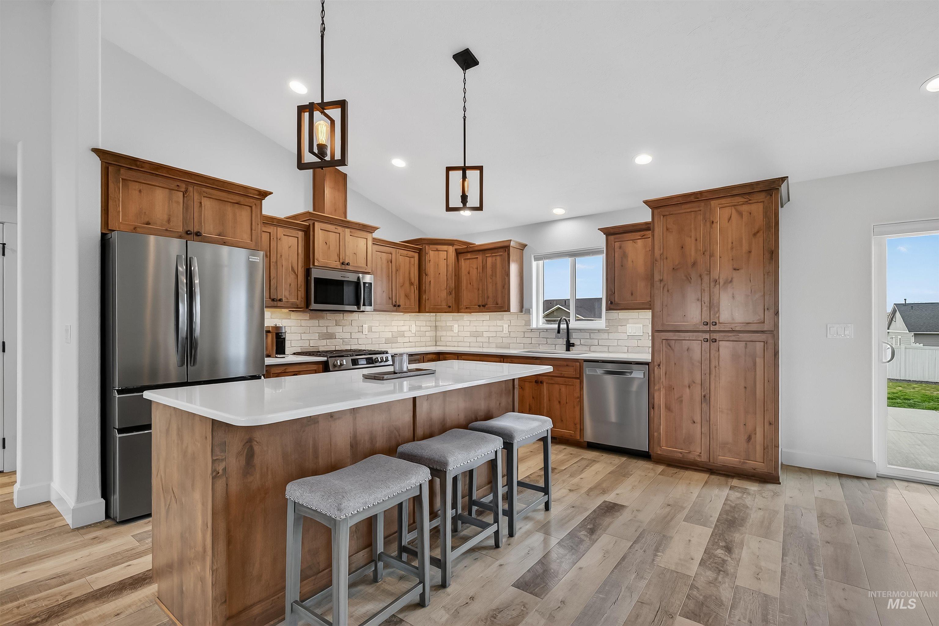 3732 Skyview Drive Lewiston, ID 83501 - Photo 6 of 47 Kitchen with wood finish cabinetry, stainless steel appliances, a kitchen breakfast bar, a kitchen island, and light wood-style floors