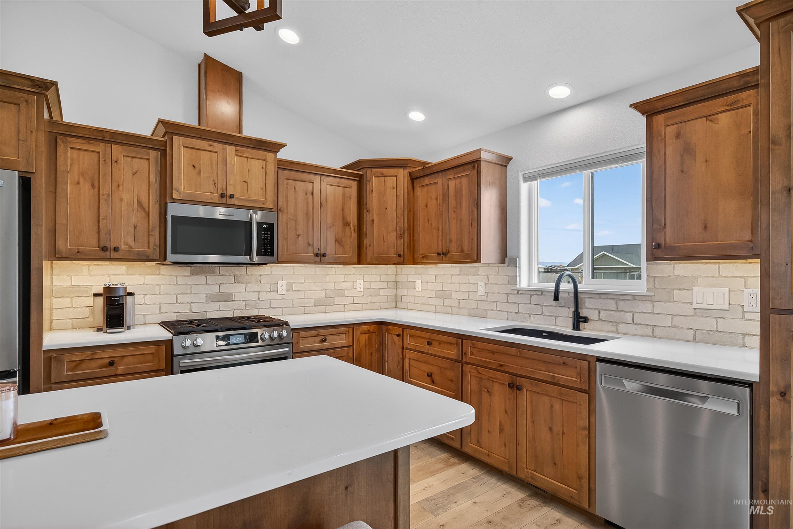 3732 Skyview Drive Lewiston, ID 83501 - Photo 7 of 47 Kitchen featuring wood finish cabinetry, stainless steel appliances, light wood-type flooring, lofted ceiling, and recessed lighting