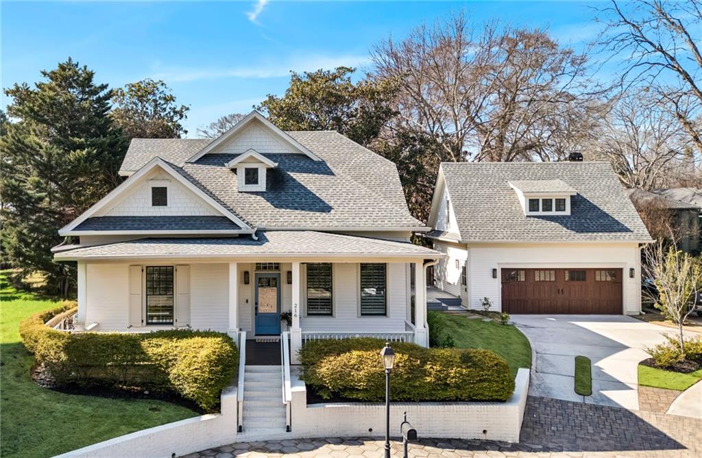 a front view of a house with yard and green space
