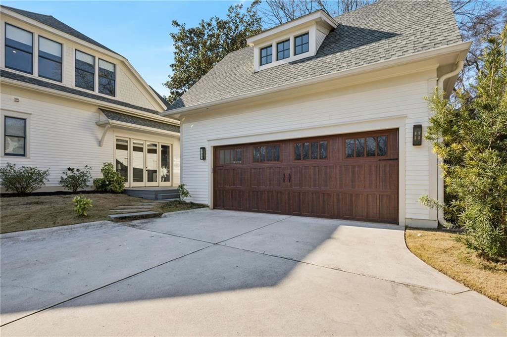 216 Haralson Lane Atlanta, GA 30307 - Photo 42 of 48 a front view of a house with a yard and garage