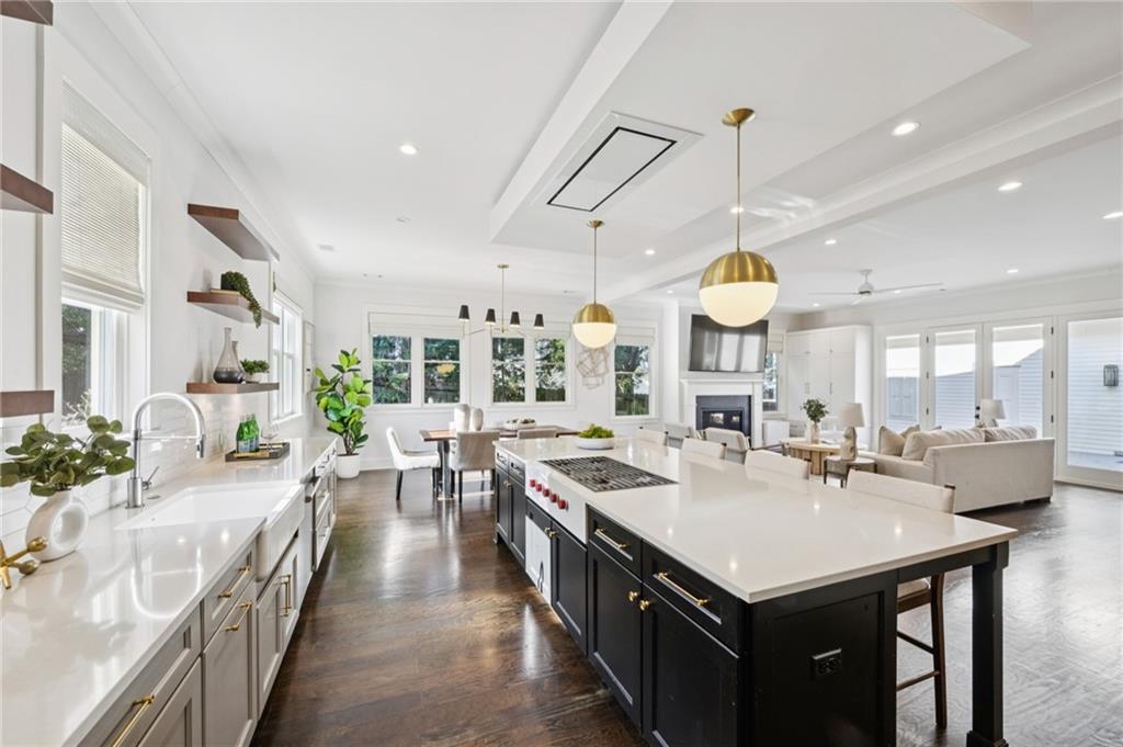 216 Haralson Lane Atlanta, GA 30307 - Photo 9 of 48 a large kitchen with kitchen island a stove a sink a dining table and chairs