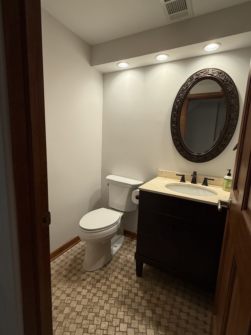 2841 Orange Brace Road Deerfield, IL 60015 - Photo 28 of 30 a bathroom with a sink toilet and a mirror