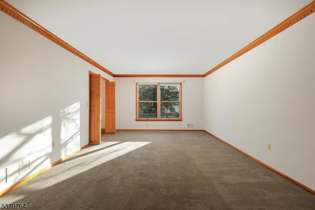 a dining room with furniture a potted plant and a chandelier