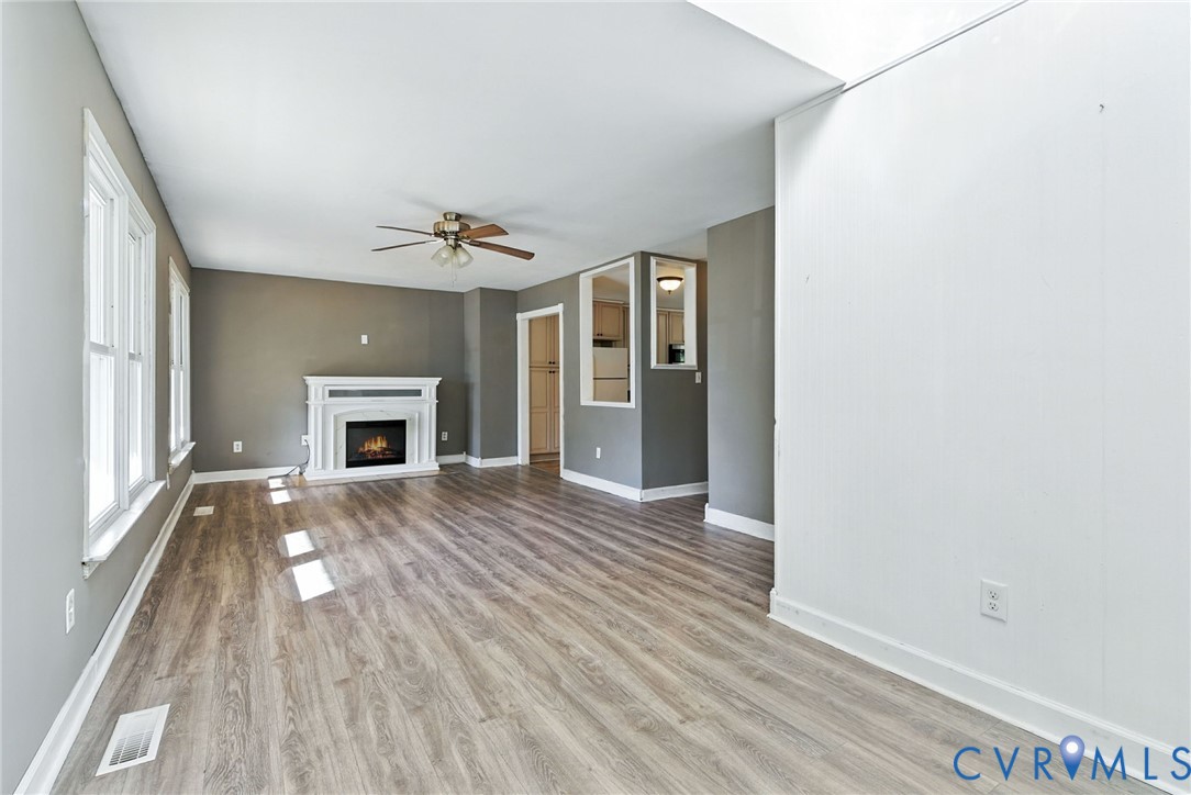 7705 Offshore Drive Chesterfield, VA 23832 - Photo 11 of 39 wooden floor in an empty room with a fireplace
