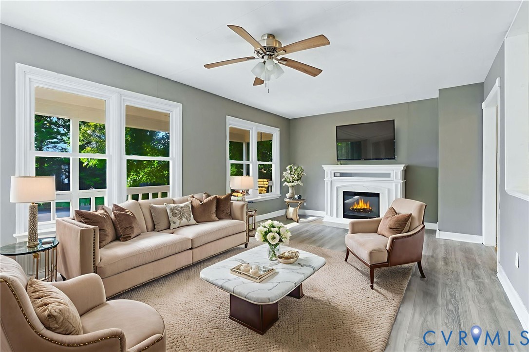 7705 Offshore Drive Chesterfield, VA 23832 - Photo 12 of 39 a living room with furniture a fireplace and a flat screen tv