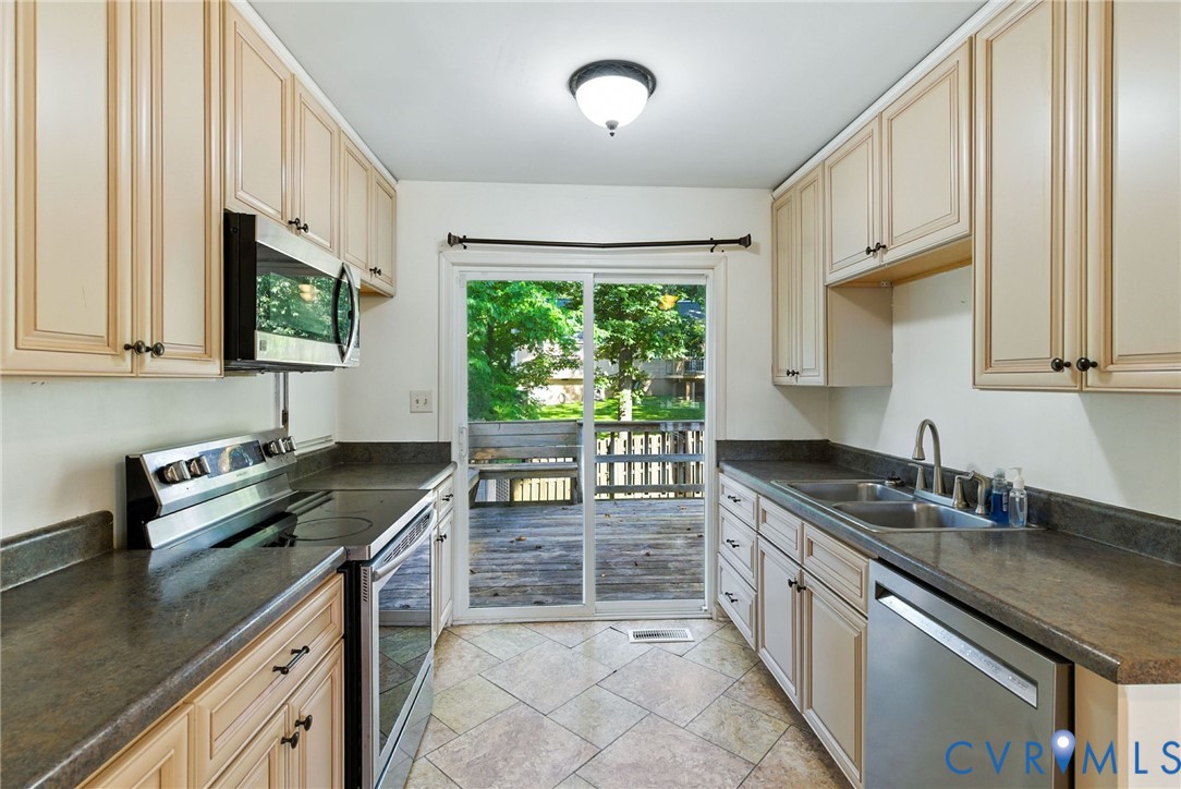 7705 Offshore Drive Chesterfield, VA 23832 - Photo 19 of 39 a kitchen with granite countertop a sink stove and cabinets