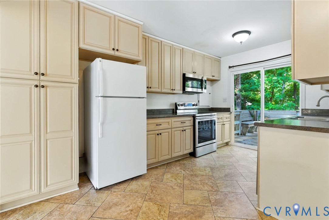 7705 Offshore Drive Chesterfield, VA 23832 - Photo 20 of 39 a kitchen with white cabinets and white appliances