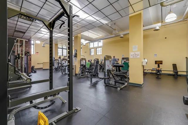a gym room with lots of gym equipment