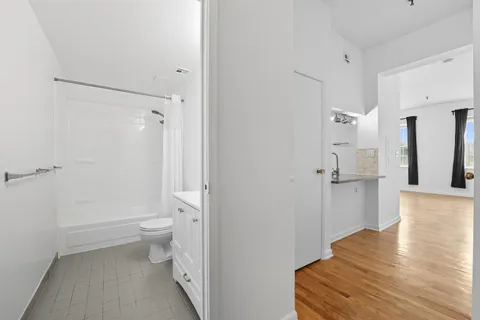 a bathroom with a toilet and a shower