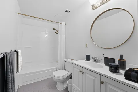 a bathroom with a sink a toilet and a mirror