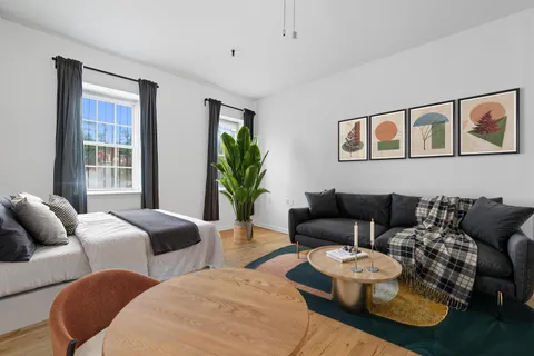 a living room with furniture and a large window