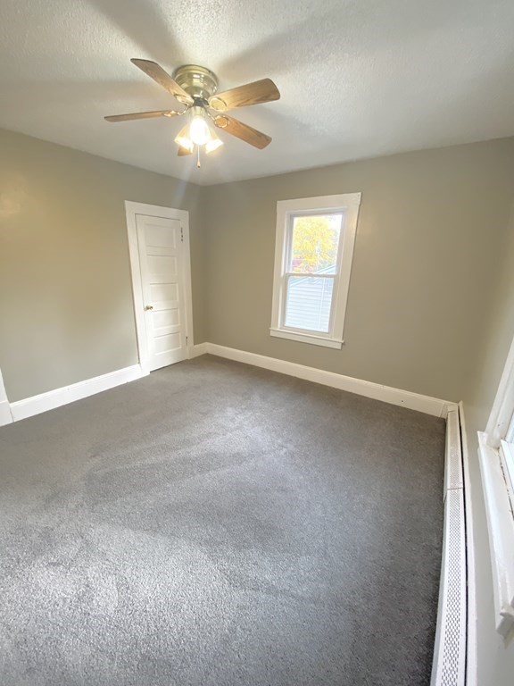 48 Boyer Street Springfield, MA 01109 - Photo 14 of 30 an empty room with windows and fan