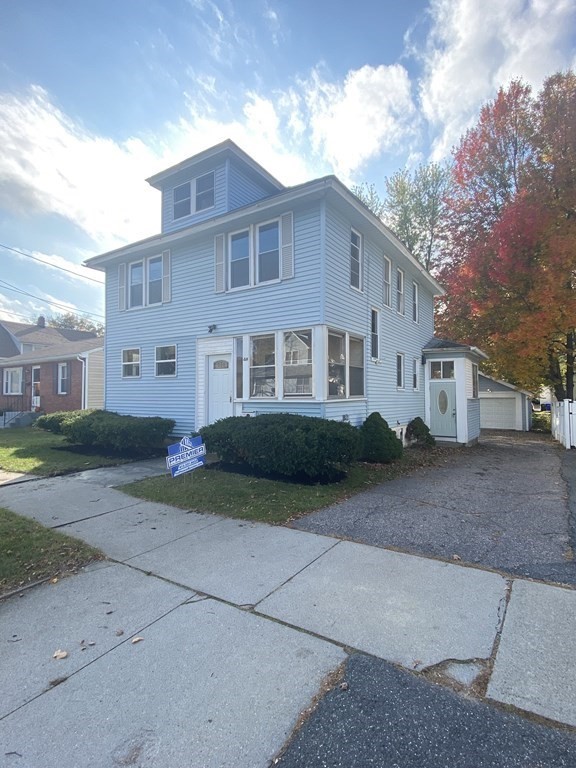 48 Boyer Street Springfield, MA 01109 - Photo 2 of 30 a view of a white house next to a yard with big trees