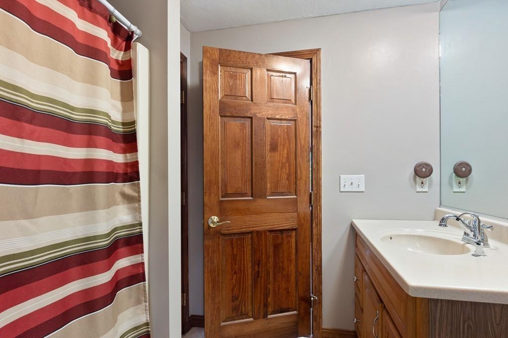 63 Russell Hill Road Ashburnham, MA 01430 - Photo 15 of 30 a bathroom with a sink a mirror and a shower curtain